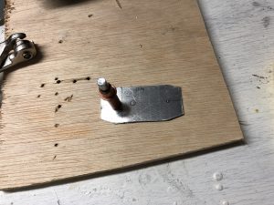 Metal piece cut and ready to drill the holes