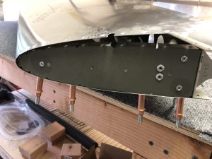 Antenna support plate riveted in place