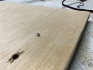 Wood piece to hold the rivet in place to shorten